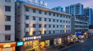 a large white building on a city street at Jinjiang Inn Wenzhou Shuangyu The Terminal in Jiangjunqiao
