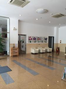 an empty lobby with chairs and paintings on the wall at Hai Duong Garden in Hải Dương