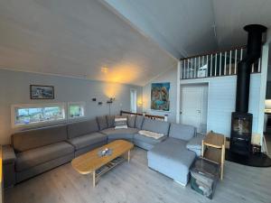 a living room with a couch and a fireplace at 10 person holiday home in Stathelle-By Traum in Stathelle