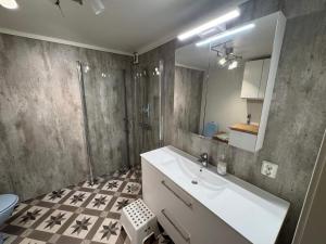 a bathroom with a sink and a shower and a toilet at 10 person holiday home in Stathelle-By Traum in Stathelle +37 photos