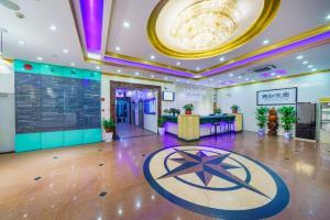 a lobby with a table and a sign on the floor at Sun Island Holiday Hotel in Shenzhen
