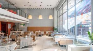 a restaurant with tables and chairs and a large window at Jinjiang Inn Hangzhou Xihu Avenue Branch in Hangzhou