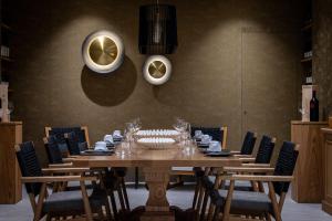 a dining room with a wooden table and chairs at Castello Boutique Suites by the sea - Adults Only in Sissi +61 photos