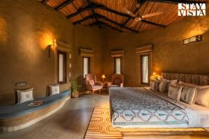 a bedroom with a large bed in a room at StayVista at The Birdwood Estate with Gym and Pool in New Delhi +43 photos