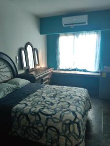 a bedroom with a large bed and a window at Shalom in Ciudad Valles