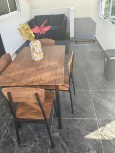 a wooden table with chairs and a vase with flowers at Shalom in Ciudad Valles