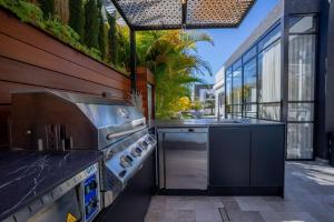 a kitchen with a stove and a grill on a patio at Villavender Boutique Suites in Netivot