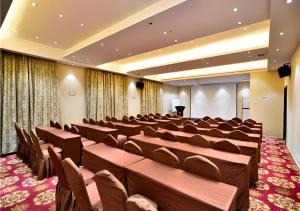 a conference room with brown chairs and a podium at City Comfort Inn Kunming Cuihu Hospital of Yunnan University Panjiawan Metro Station in Kunming
