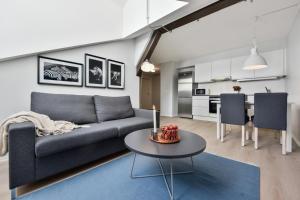 a living room with a couch and a table at Forenom Serviced Apartments Oslo Vika in Oslo