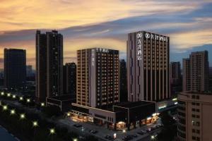 a city skyline with tall buildings and street lights at 先泽酒店 in Huadu