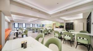 a large room with tables and chairs in a building at GreenTree Inn Beijing Changping District North China Electric Power University Business Hotel in Yongfengtun