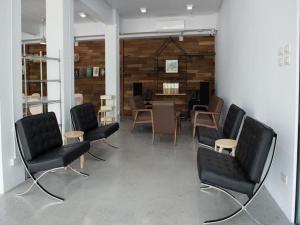 a room with chairs and a dining room with a table at Veethara boutique hotel in Udon Thani