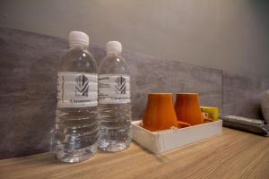 a bottle of orange juice sitting on top of a table at Chariton Hotel Alma in Bukit Mertajam