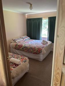 a bedroom with two beds and a window at Serene Vista Halls Gap in Halls Gap