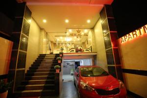 a red car parked in front of a garage at New Hotel & Apartment in Thu Dau Mot