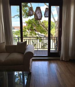 a living room with a couch and a large window at Luxe Hideaway in Colombo