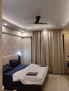 a bedroom with a bed with a ceiling fan at Exotic resort -basai Kashipur ramnagar road in Gaushala