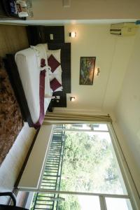 a room with a bed and a window at Exotic resort -basai Kashipur ramnagar road in Gaushala