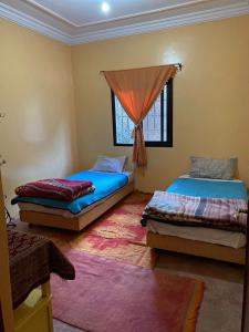 Un pat sau paturi într-o cameră la riad dar imlil