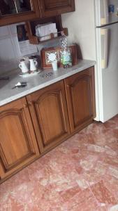 een keuken met houten kasten en een witte koelkast bij 87 Apt in Bologna