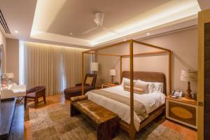 a bedroom with a canopy bed and a desk at The Grand Luxxe Res Two Bedroom Loft- Riviera Maya in Nuevo Vallarta  +105 photos