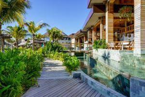 a walkway next to a resort with a swimming pool at The Grand Luxxe Res Two Bedroom Loft- Riviera Maya in Nuevo Vallarta 