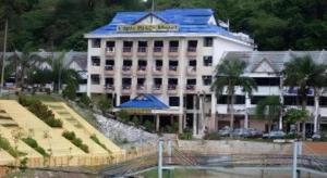 a hotel with a blue roof and a building at Lipis Plaza Hotel in Kuala Lipis