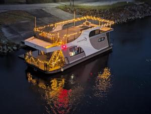 a boat sitting in the water with lights on it at Hausboot bei Passau in Windorf