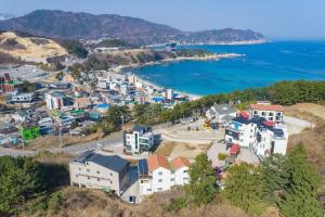 an aerial view of a town next to the water at Janghohang Ilmare Pension in Samcheok