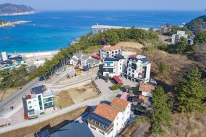 an aerial view of a city with the ocean at Janghohang Ilmare Pension in Samcheok