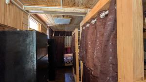 a hallway in a tiny house with a curtain at Monkstel Cottages Shangarh in Shangarh +55 photos