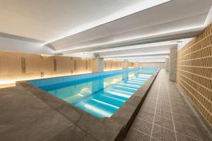 a large swimming pool in a building at Wyndham Leshan Downtown in Leshan