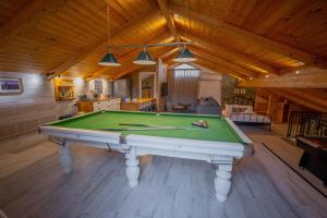 a pool table in the middle of a room at Villavender Boutique Suites in Netivot