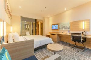 a hotel room with a bed and a sink at City Comfort Inn Wuhan Rui'an Street Metro Station in Wuhan