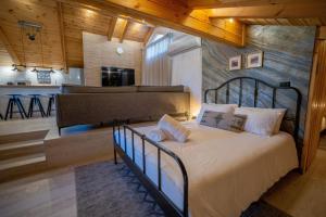 a bedroom with a bed in a room with a kitchen at Villavender Boutique Suites in Netivot