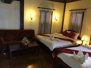 Una cama o camas en una habitación de Villa Le Tam Tam Boutique Hotel