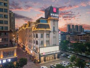 a building with a sign on it in a city at Echarm Hotel Baise Sports Center Dream Island Plaza in Qitang