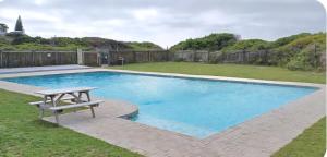 a swimming pool with a picnic table in a yard at The Tidal Court in Sea Vista