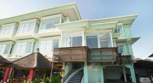 a house with a balcony on the front of it at The Studio Inn Nusa Dua in Nusa Dua