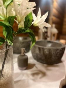 a vase with flowers in it sitting on a table at Kosmajska Bajka in Rogača