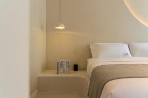 a bedroom with a bed and a book on a table at Yijianju Garden Inn in Lijiang