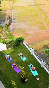 a group of people doing yoga on the grass at Django Villa Weligama in Weligama +83 photos