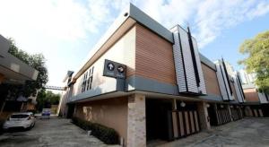 a building with a car parked in front of it at Sriracha Hotel And Spa in Ban Bang Phra
