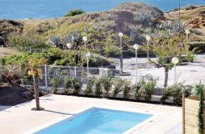 a swimming pool with a view of the ocean at Résidence Thalacap in Cap d'Agde