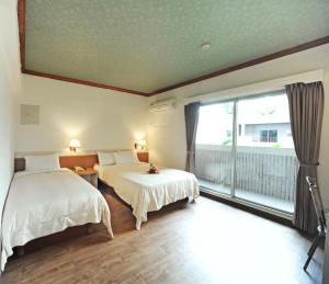 Postel nebo postele na pokoji v ubytování Kenting Holiday Hotel