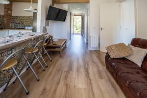 a living room with a couch and a table at Rural apartment La Cantonada in Guardiola de Berguedà
