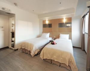 Postel nebo postele na pokoji v ubytování Kenting Holiday Hotel