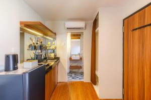 a kitchen with a sink and a refrigerator at Andewi Cabin in Canggu