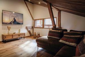 a living room with a couch and a table at Chalet Trumont - OVO Network in Morillon +18 photos