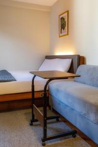 a room with two beds and a table in it at Andewi Cabin in Canggu